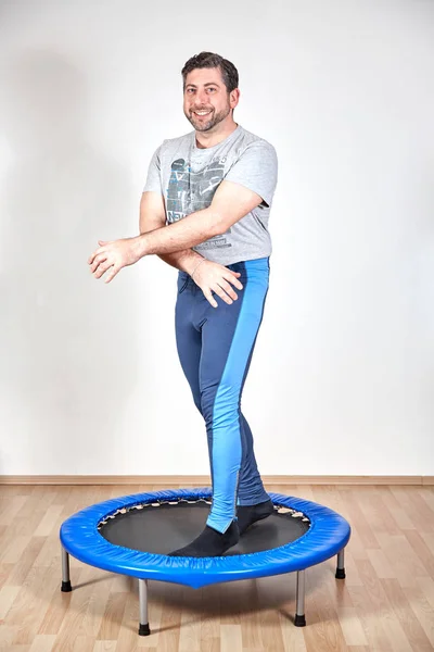 Man doing workout at home in trampoline