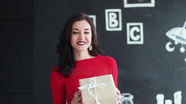 A Beautiful Girl Has Received a Gift For Christmas or a Birthday. She is Happy and Smiling. it is Funny, Charismatic and Attractive. — Stock Video