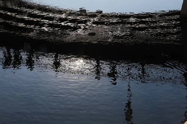 Nehirdeki insanların yansıması.