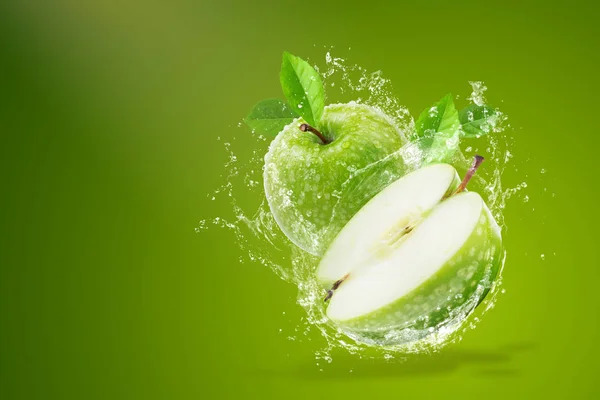 Wasser spritzt auf frischem grünen Apfel auf grünem Hintergrund — Stockfoto