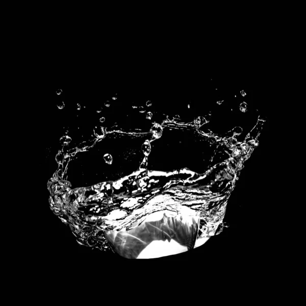 Water splashing isolated over a black background. — Stock Photo, Image