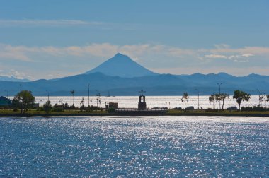 View of the monument to Peter and Paul and Vilyuchinsky volcano from Petropavlovsk-Kamchatsky, Kamchatka. clipart