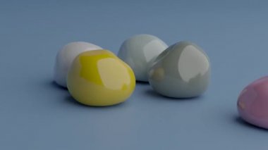 Zıplayan toplar düşer. Dönüşüm küreleri hareketi. Yumuşak vücut fiziği 3D görüntüleme. Lastik şekillerin neşeli animasyonu zıplıyor. Mavi arkaplana düşen renkli sıvı nesneler. 