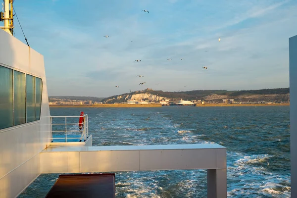 Early morning spring sunshine as a cross channel ferry departs the Port of Dover, Kent, UK heading for Calais, France