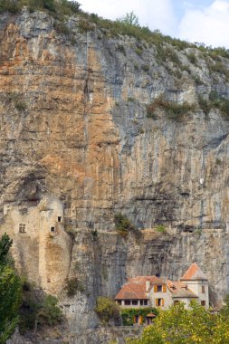 Quaint village houses and a ruined castle built into the cliffs at Cabrerets, Lot, France, Europe clipart