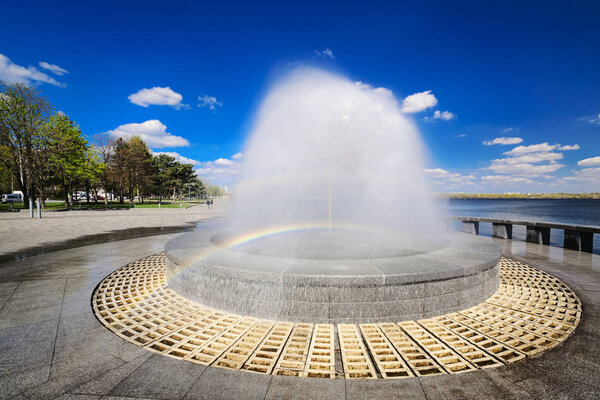 Beautiful fountain against the blue sky with clouds I