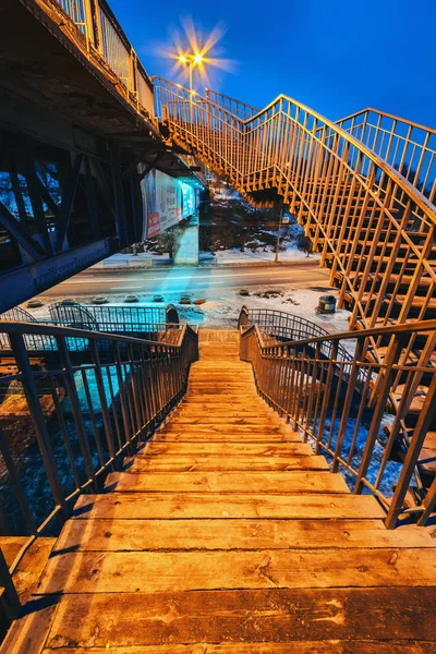 Deserted pedestrian bridge at night in the lighting of street lamps II