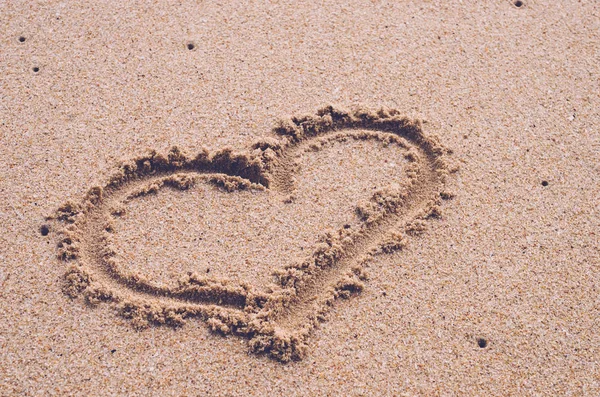 Heart drawing on sand beach