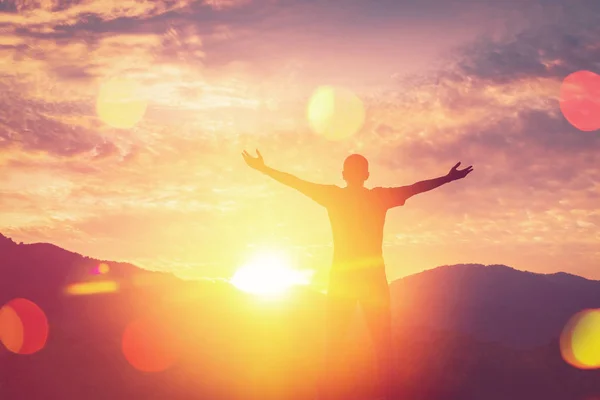 Copy space of man rise hand up on top of mountain and sunset sky abstract background. — Stock Photo, Image