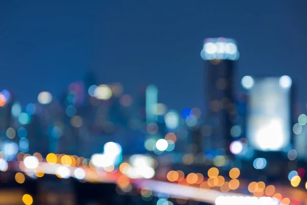 Blurred lights cityscape downtown at twilight, abstract background — Stock Photo, Image