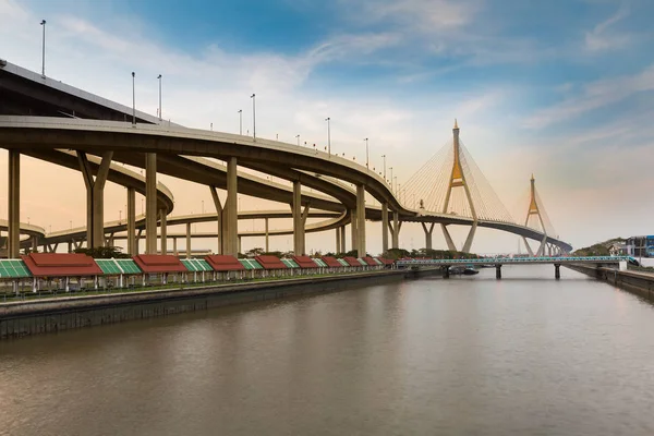 Suspension bridged connect to highway overpass crossing river — Stock Photo, Image