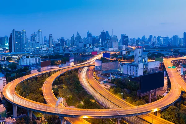 Long exposure, highway road curved with city downtown