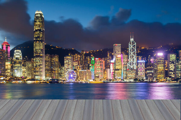 Opening wooden floor, abstract blurred bokeh lights Hong Kong city water front night view