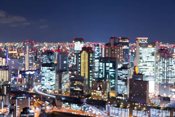 Ciudad borrosa bokeh luz del centro de la ciudad con azul crepúsculo horizonte — Foto de Stock