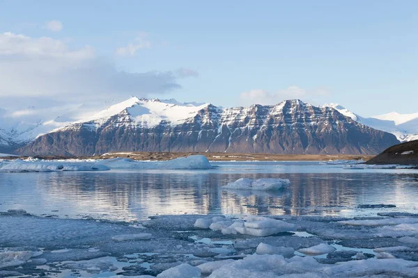 Beautiful Jokulsarlon winter lake with mountain and blue sky background