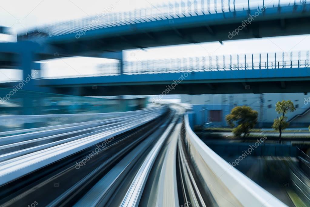 Blurred motion railway moving into city