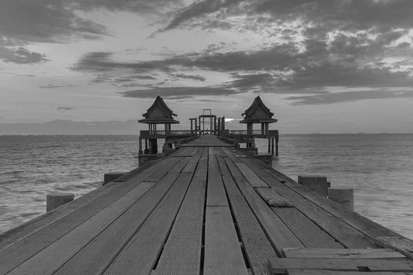 Wooden floor walking way leading to temple in ocean skyline, natural abstract background