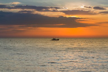 Küçük balıkçı teknesi sahil manzarası ve güneş battıktan sonra 