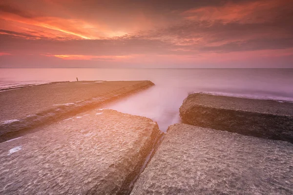 Rock on seacoast with sunrise tone — Stock Photo, Image