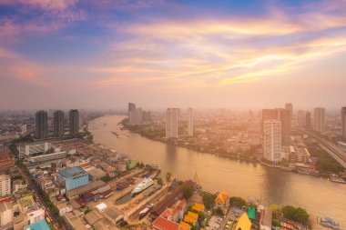 Günbatımı gökyüzü arka plan üzerinde kavisli nehir ve şehir havadan görünümü