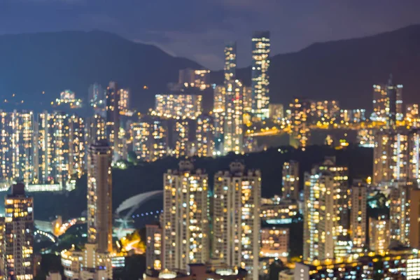 Night light city of Hong Kong blurred bokeh light residence area over high hill