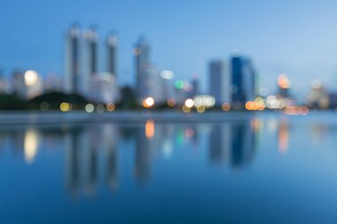 Su yansıması ile alacakaranlıkta bokeh şehir ışık bulanık