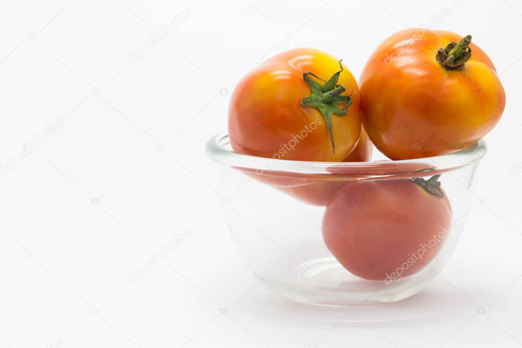 Fresh tomato on glass bowl