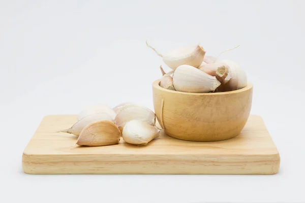Drewniane miski z root czosnku, na białym — Zdjęcie stockowe