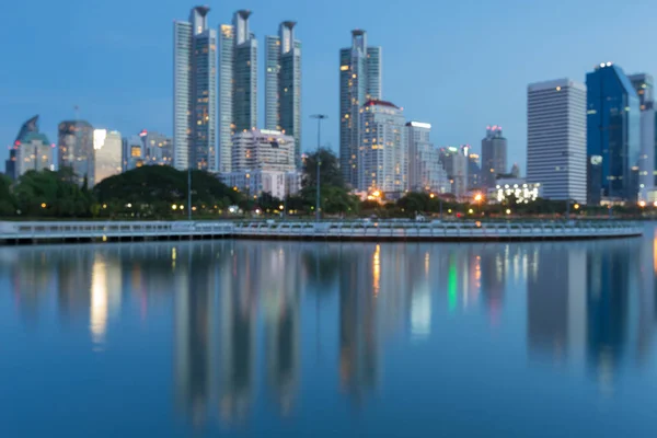 Blue twilight with reflection office building blurred bokeh light — Stock Photo, Image