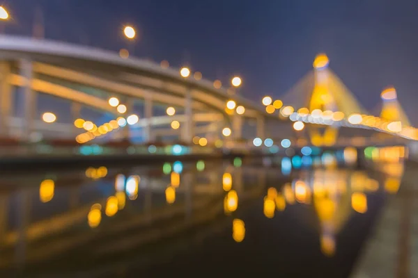 Night blurred bokeh bridge with river reflection — Stock Photo, Image