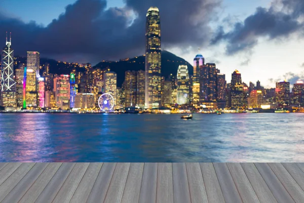 Opening wooden floor, Night blurred bokeh light Hong Kong city sea front, abstract background