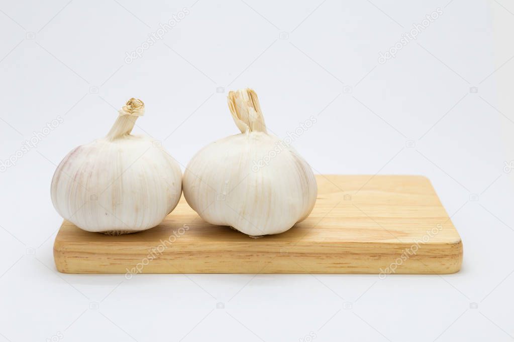 Garlic on wooden floor, white background nutitation food