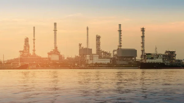 Refinery chemical industry plant river front during sunset