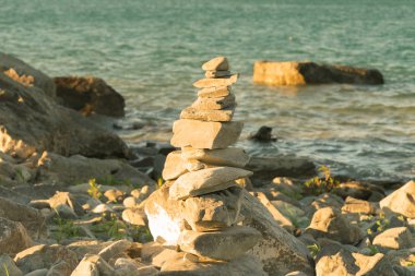 Yığın taş göle bakmaktadır, doğal arka plan