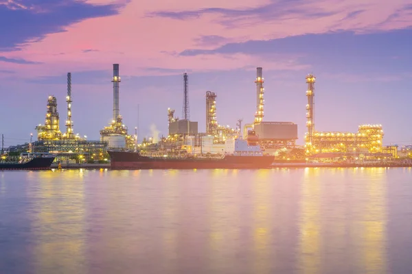 Beauty of after sunset sky over oil refinery, industry background water front