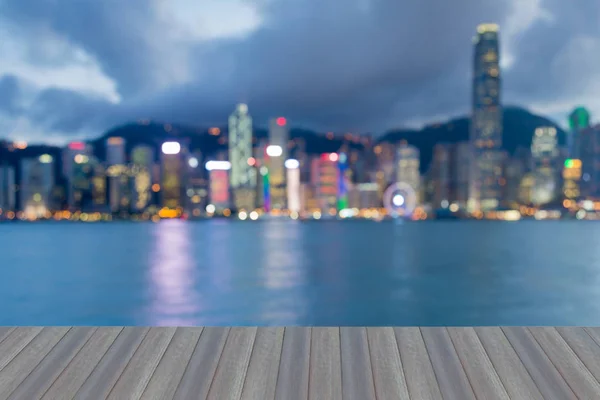 Opening wooden floor, Night Hong Kong blurred bokeh light sea front, abstract background