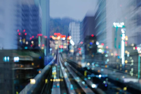 Train track motion blurred moving into bokeh light  city downtown, abstract background