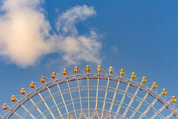 Alt görünümü, mavi gökyüzü ve bir eğlence parkı demek beyaz bulut karşı dev dönme dolap 
