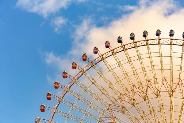 Fun fair amusement giant wheel with blue sky background