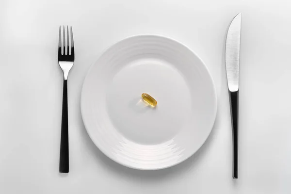 Table Setting White Plate Filled Yellow Capsule Omega Next Cutleries — Stock Photo, Image