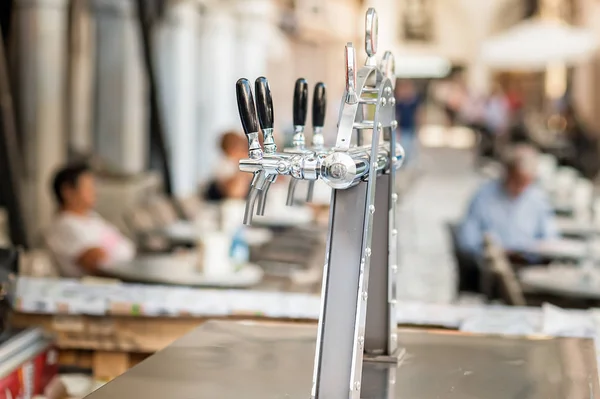 Draught beer taps and other beverages. — Stock Photo, Image