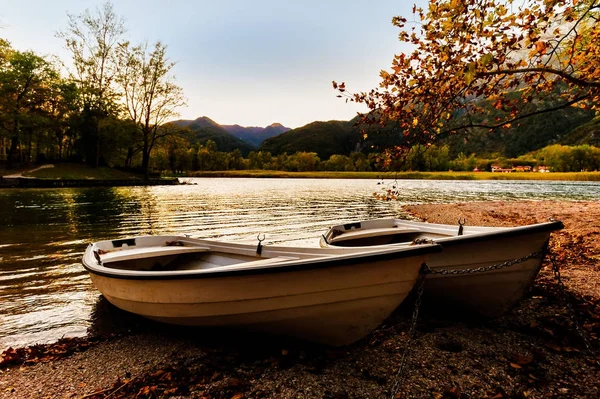 Two boats on the lake shore at sunset. — Stock Photo, Image