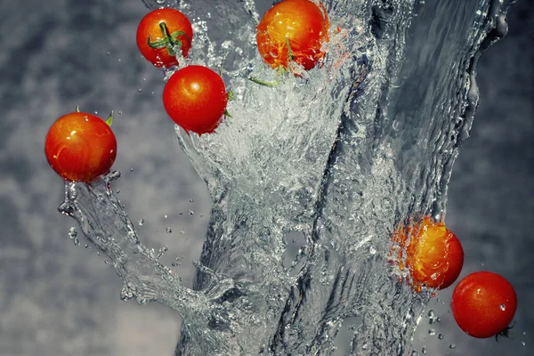 Fresh Red Cherry Tomatoes Splashing through Fresh Water