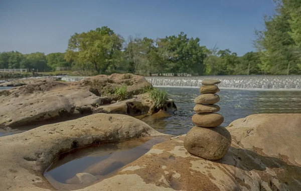 Zen stone mountain by the river with waterfalls and trees in the background — Stock Image Zen Stone Mountain River Waterfalls Trees Background Royalty Free Stock Images