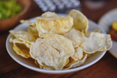 Emping are a type of Indonesian chips, a bite-size snack kripik cracker, made of melinjo or belinjo (Gnetum gnemon) nuts (which are seeds) clipart
