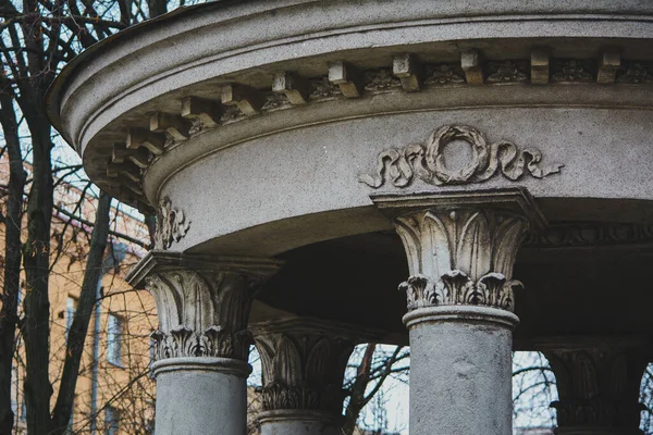 concrete arbor with columns and stucco molding