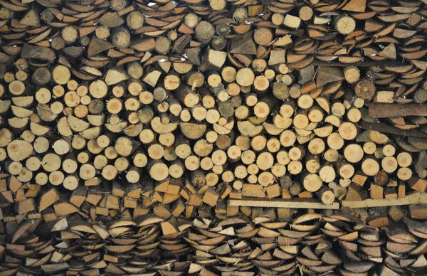 stacked wooden pieces of different shapes. firewood. wood texture