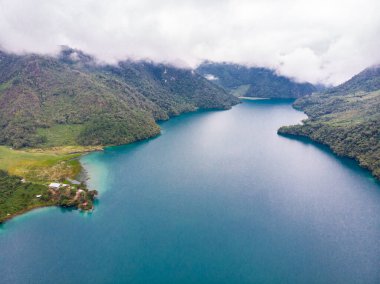 Guatemala 'daki Laguna Brava' nın hava manzarası bulutlu bir günde turkuaz suyunu ve gölü çevreleyen güzel dağları görebilirsiniz..
