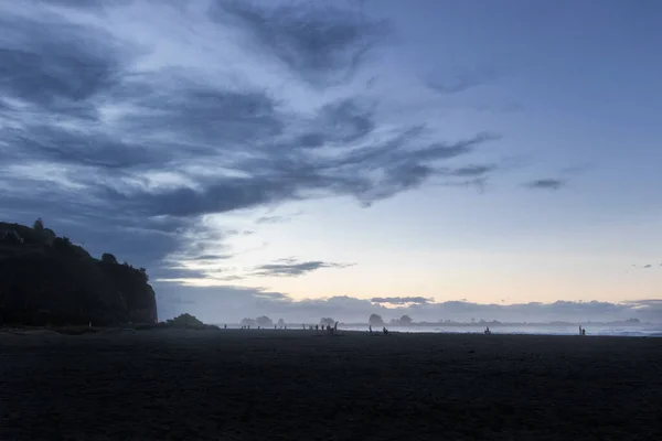 Scenic picture of a beach during the sunset with people playing before the sunset. New Zealand, Christchurch outdoor