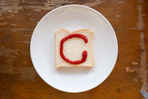 bread of breakfast is written C by ketchup on write plate. A to Z and Number and Special characters set.